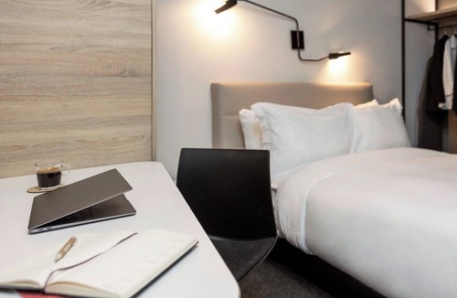 Brossard Hotel | Enjoy Functional Elegance in Spacious Room w/Kitchenette + Dining Table