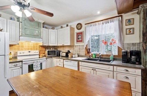 Northern Bruce Peninsula House | Escape to Three Bears Cottage, a cozy cedar-lined cottage just two blocks from Lake Huron. Enjoy evenings by the fireplace, mornings on the wrap-around porch, and peaceful moments surrounded by nature on the beautiful Bruce Peninsula.