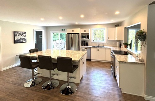 Lion's Head Cabin | Pike & Pine: This bright and spacious retreat blends modern comfort with cozy cottage charm. Featuring a fully equipped kitchen, multiple cozy bedrooms, stylish bathrooms, and inviting living spaces with a wood-burning fireplace.