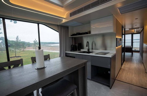 Runaway Bay Apartment | Vessel 10 - Elevated Vessel Experience | Waterfront Backyard Fast Internet