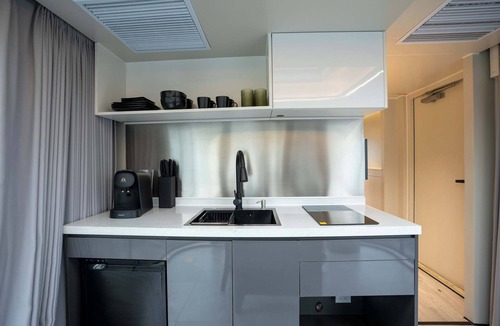 Runaway Bay Apartment | Vessel 10 - Elevated Vessel Experience | Waterfront Backyard Fast Internet
