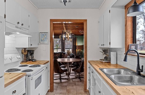 Uncertain House | Warm, Rustic Lodge with private dock access directly across the street, featuring a firepit & picnic table for outdoor dining
