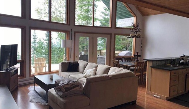 Marvel at breathtaking views surrounding you from this waterfront chalet