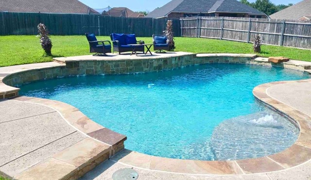 Spacious 6-bedroom house with pool and hot tub and theater room next to stadium!