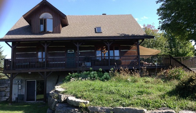 Waterfront log home on Lake Dore. Decks, dock, outdoor hot tub and fire pit.